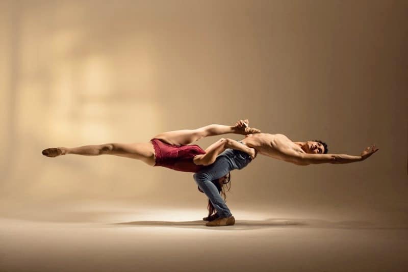 Acrobatic dancing pair doing hard pose Stock Photo - Alamy